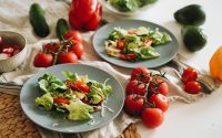A vibrant plate of fresh salad featuring cherry tomatoes, avocado, and colorful veggies.